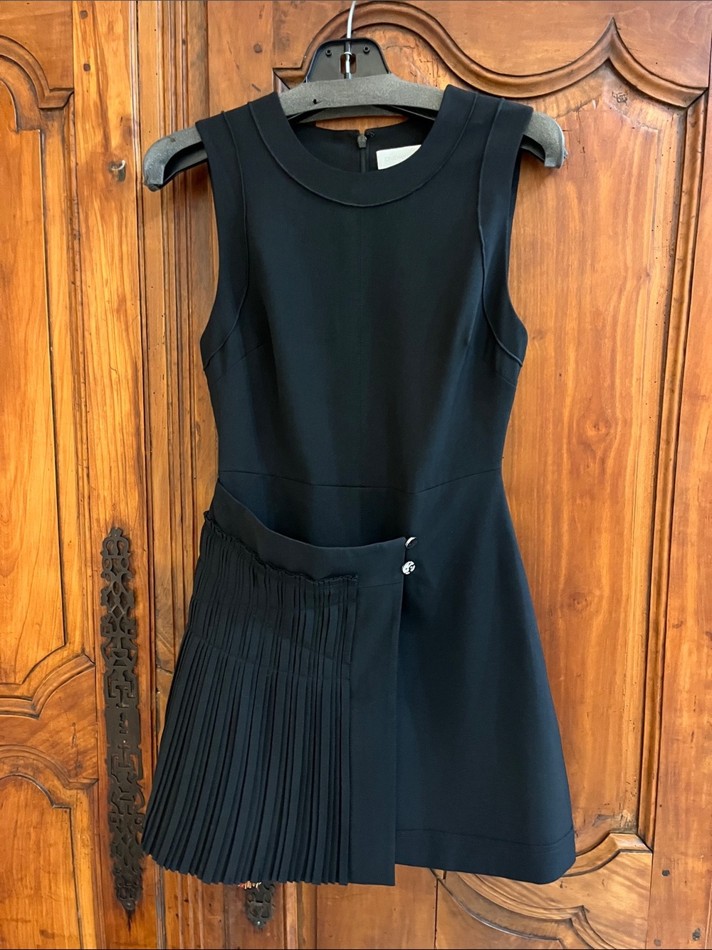Sleeveless Black Mini Dress with Pleated Skirt Detail